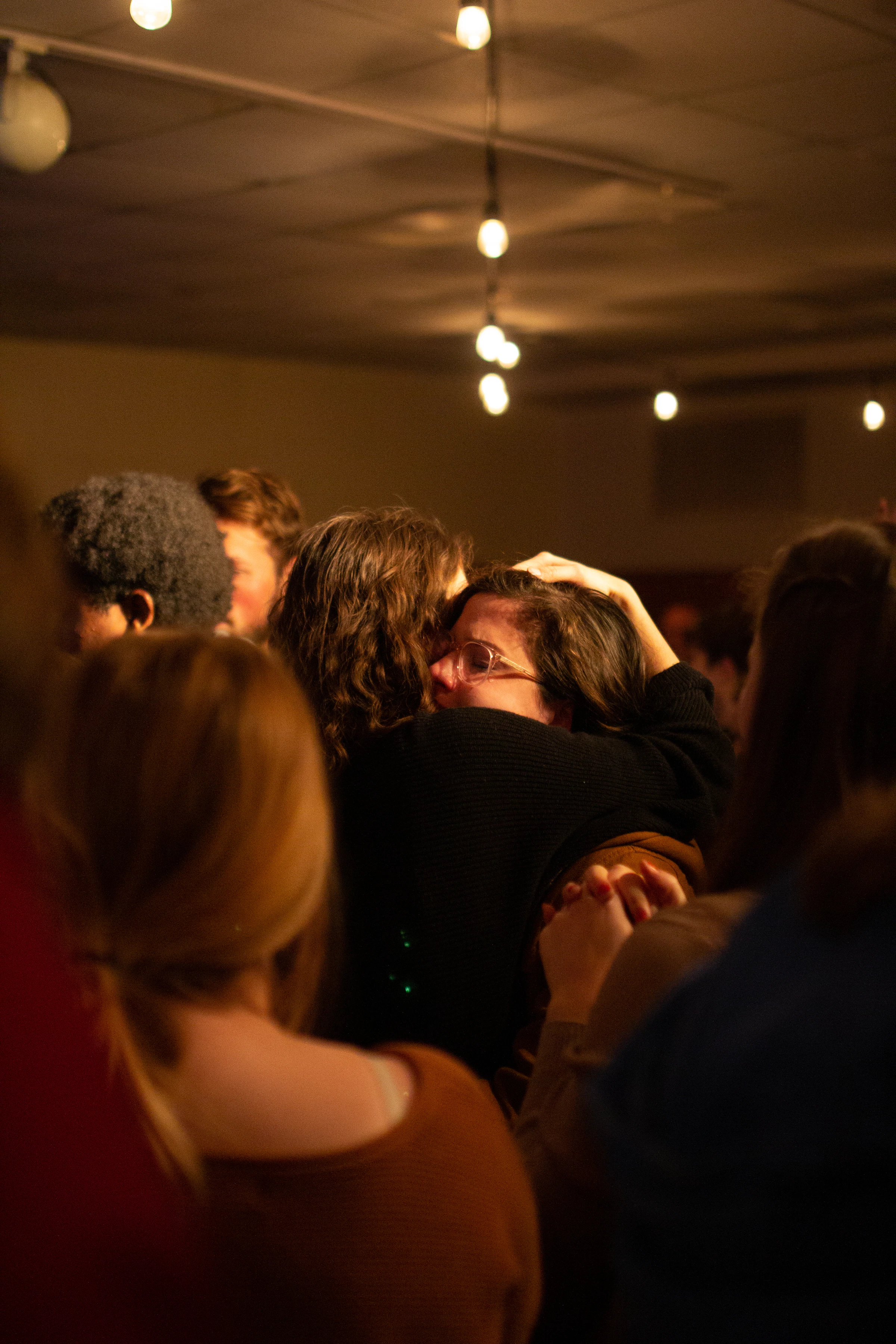 People in a dimly lit bar with a vibrant nightlife atmosphere