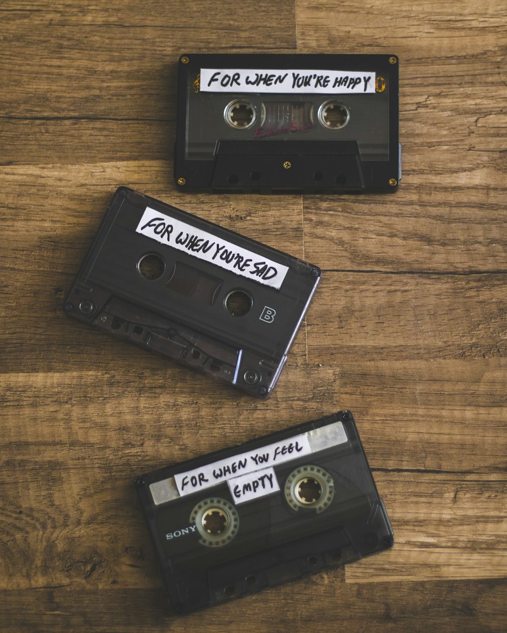 black cassette tape on brown wooden table