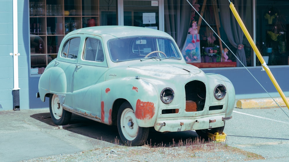 white vintage car parked on gray concrete floor