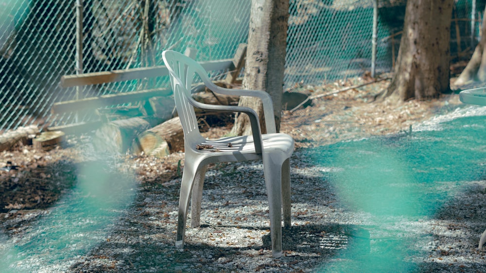 white plastic armchair on swimming pool