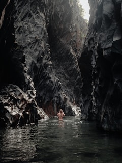 people swimming on river during daytime