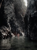 people swimming on river during daytime