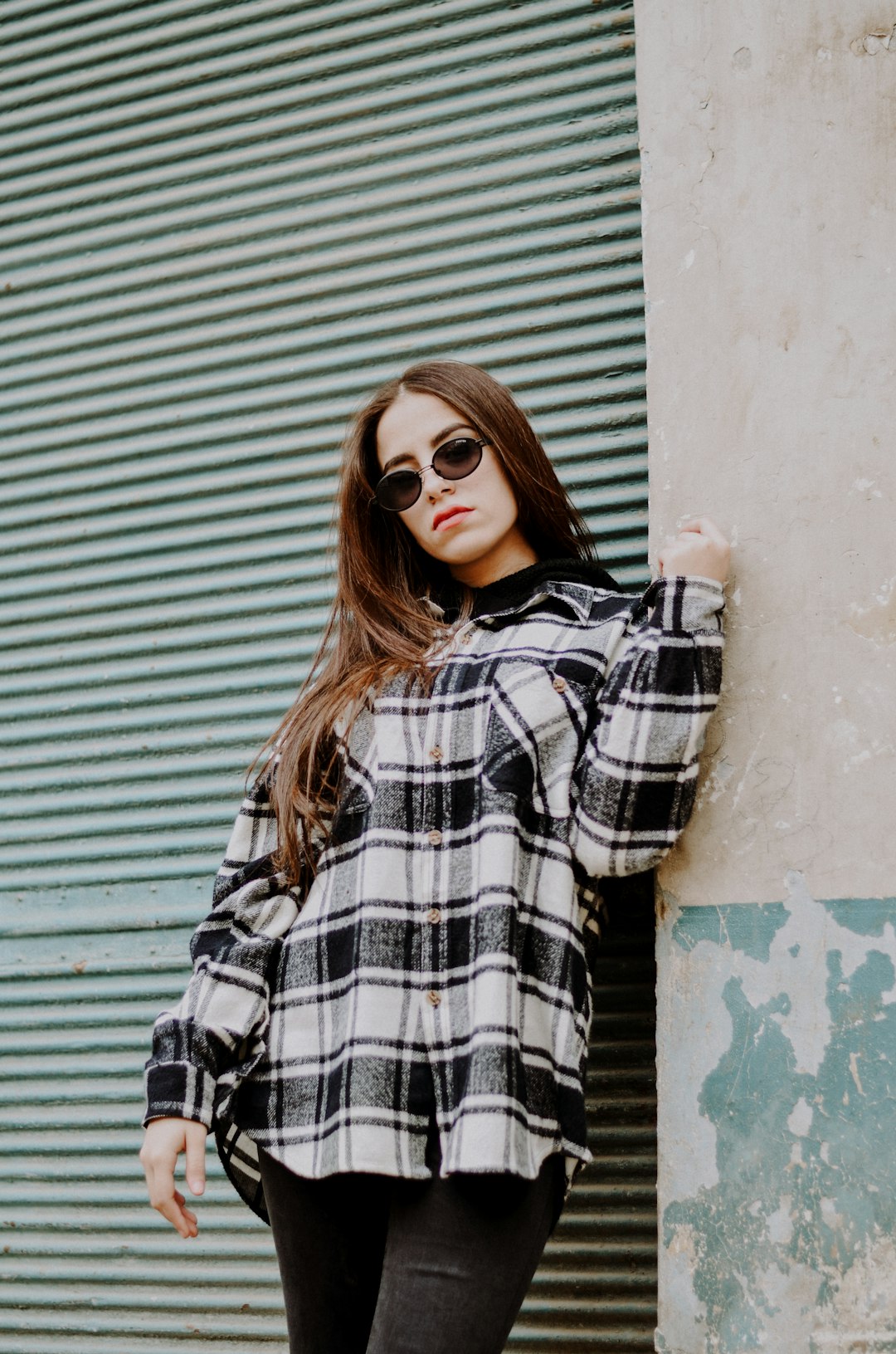 woman in black and white plaid long sleeve shirt wearing black sunglasses