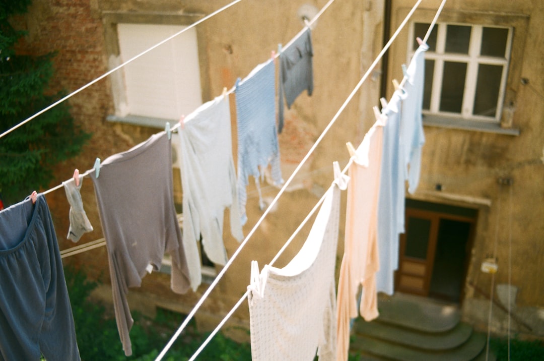 white and blue clothes hanging on brown wooden clothes hanger