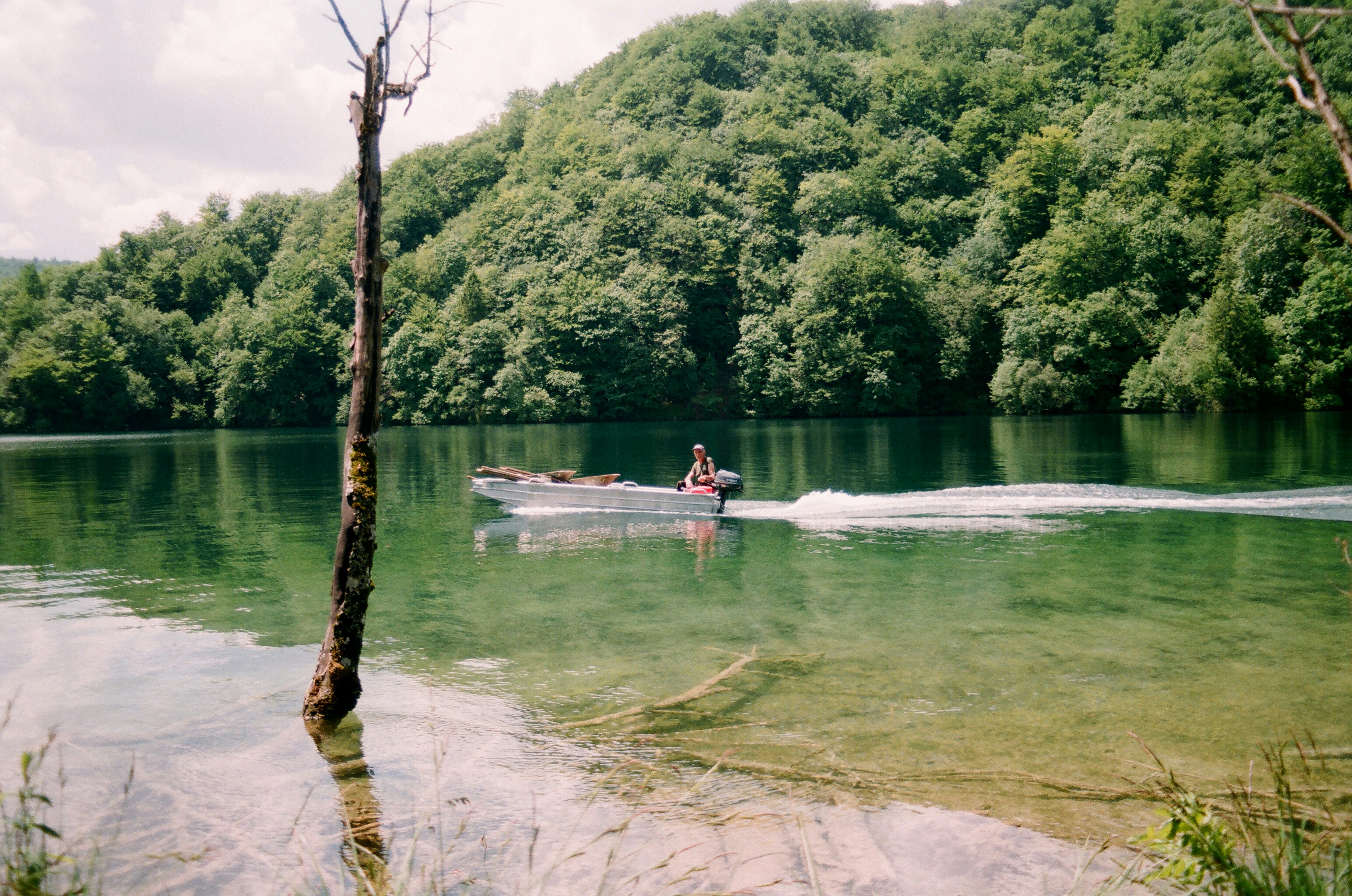man riding on white boat on river during daytime