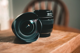 black dslr camera lens on brown wooden table
