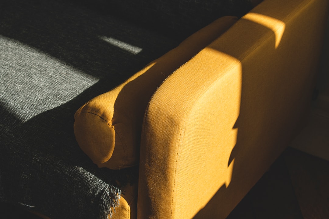 brown suede couch on black carpet