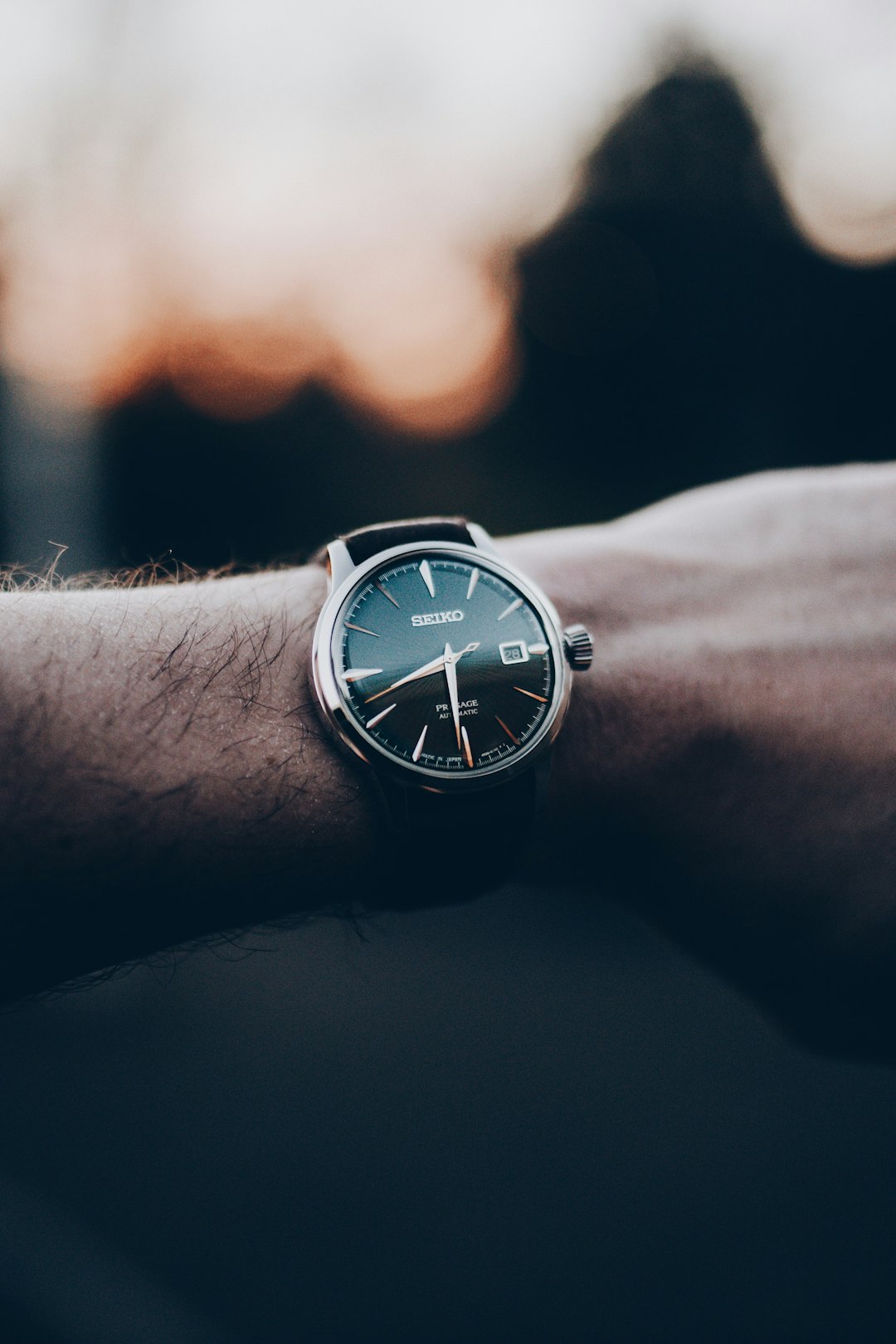 person wearing silver analog watch