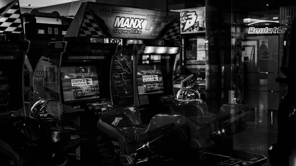 grayscale photo of motorcycle parked near store