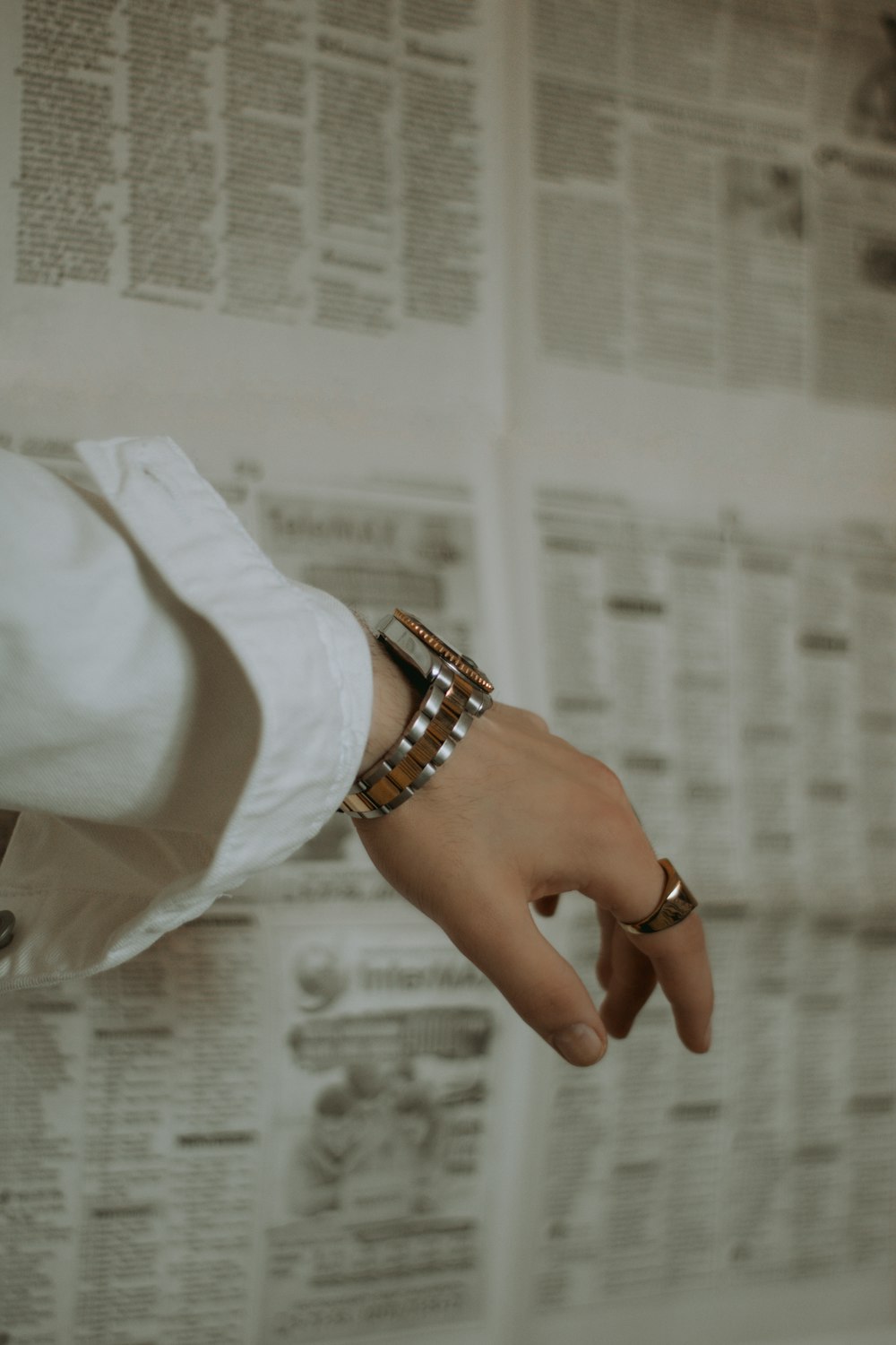 person wearing silver link bracelet watch