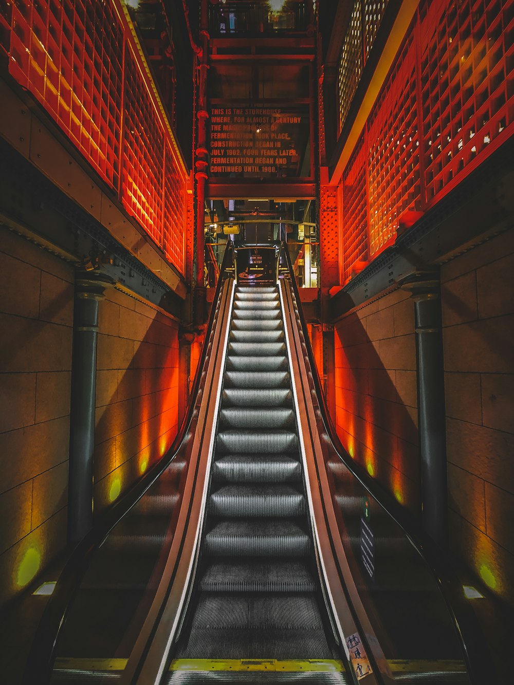 black and red escalator in a tunnel