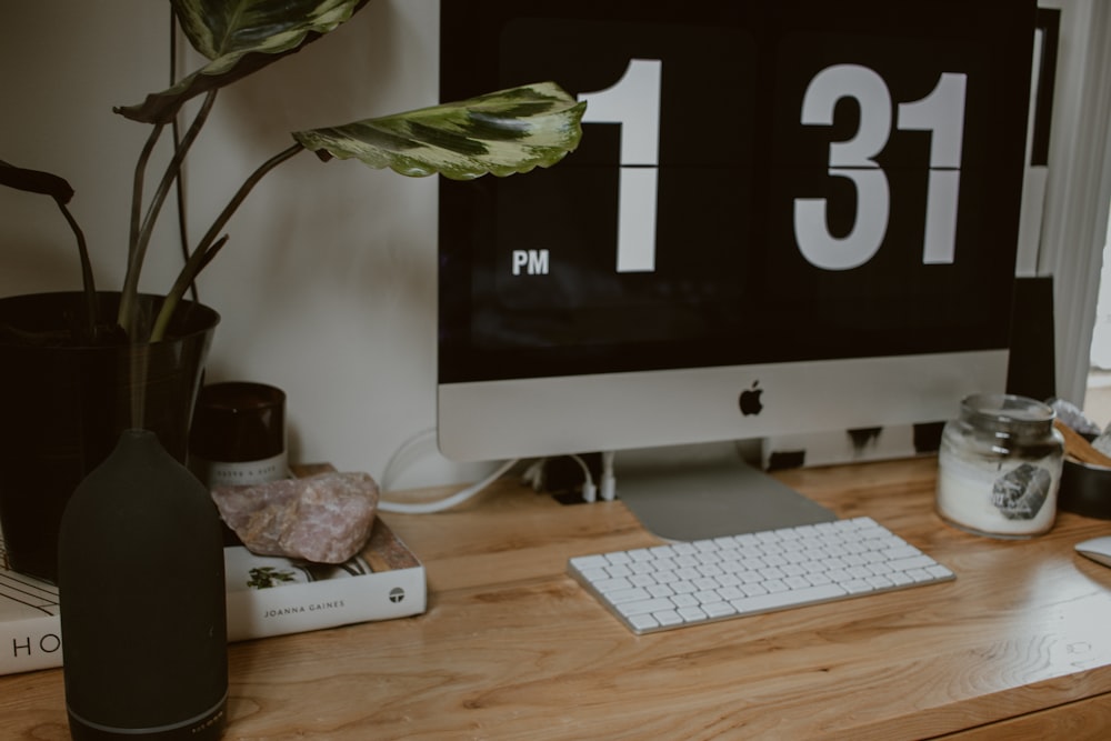 silver imac on brown wooden table