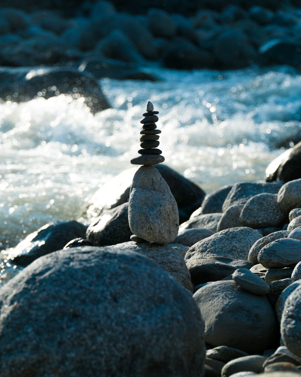 gray and black stone near body of water during daytime