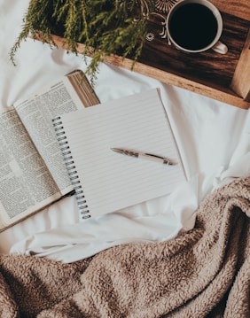 white notebook on white textile