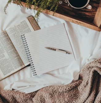 white notebook on white textile