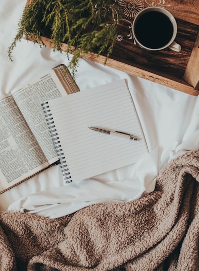 white notebook on white textile