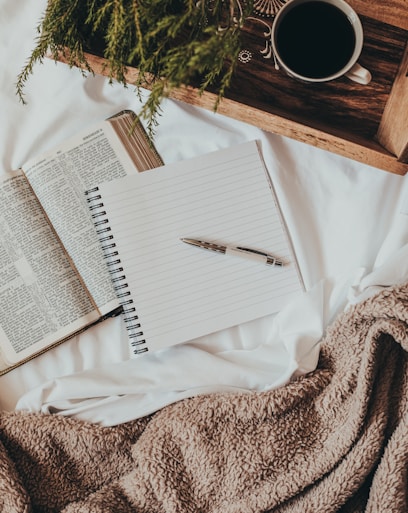 white notebook on white textile