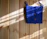 Close-up of a handmade knitted bag resting on a wooden table with soft natural light.