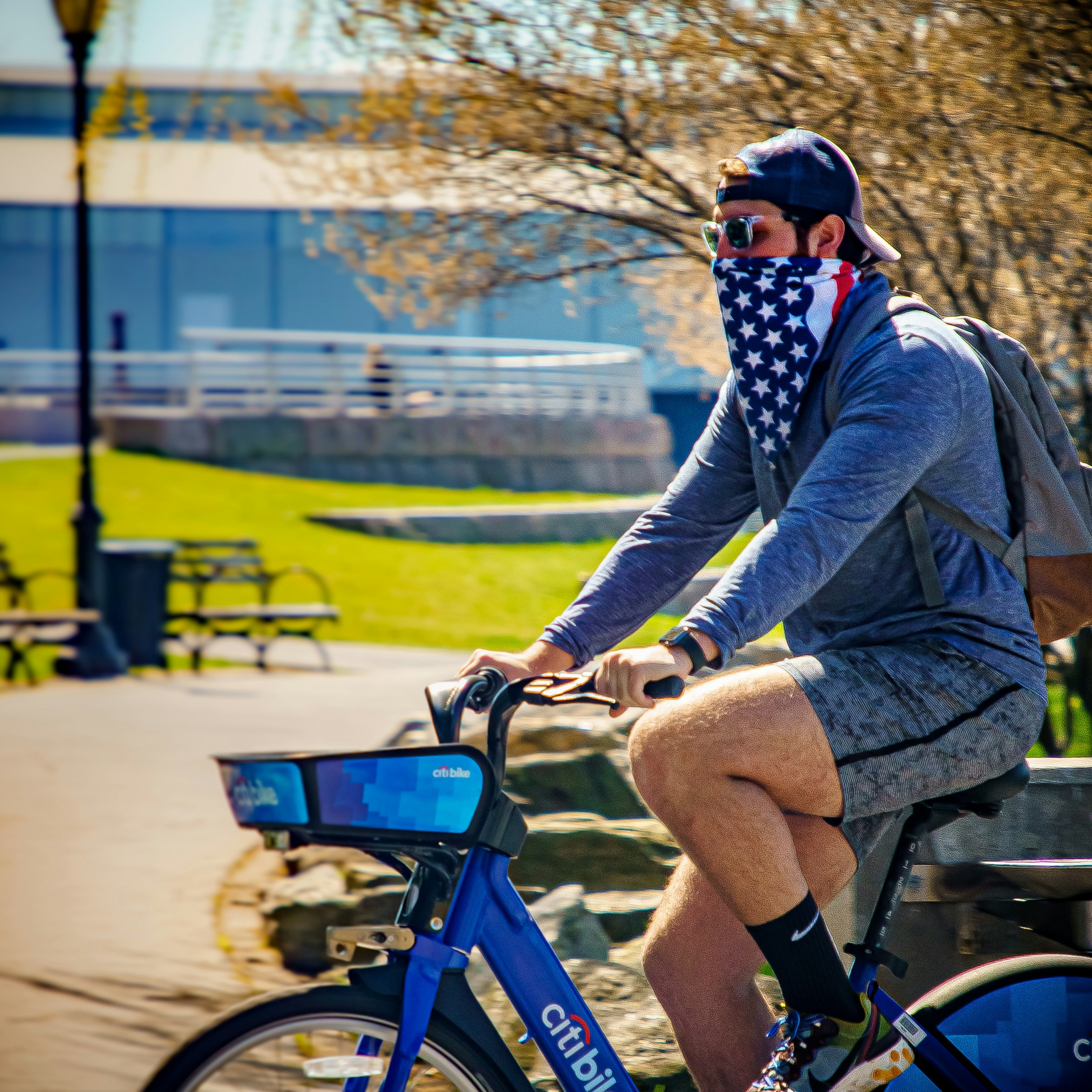 woman in black jacket riding bicycle during daytime