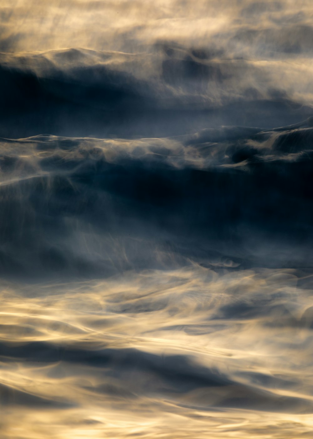 white clouds over mountains during daytime