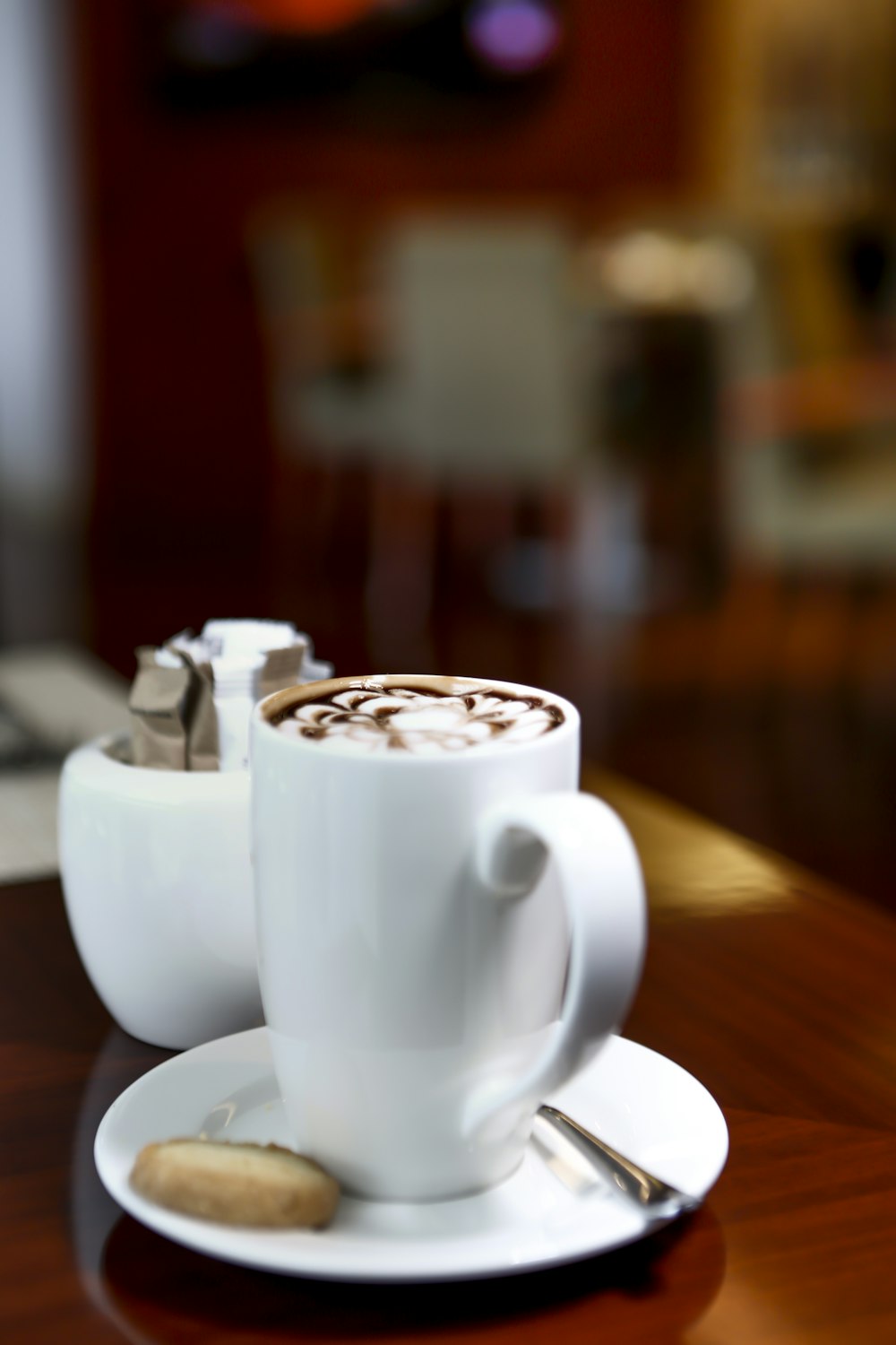 white ceramic cup on white ceramic saucer