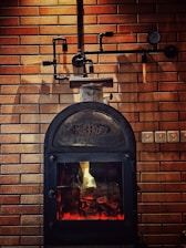 Repair expert fixing an oven stove in a cozy home setting.
