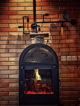 Industrial-style rocket stove displayed on a modern kitchen counter, showcasing its architectural design.