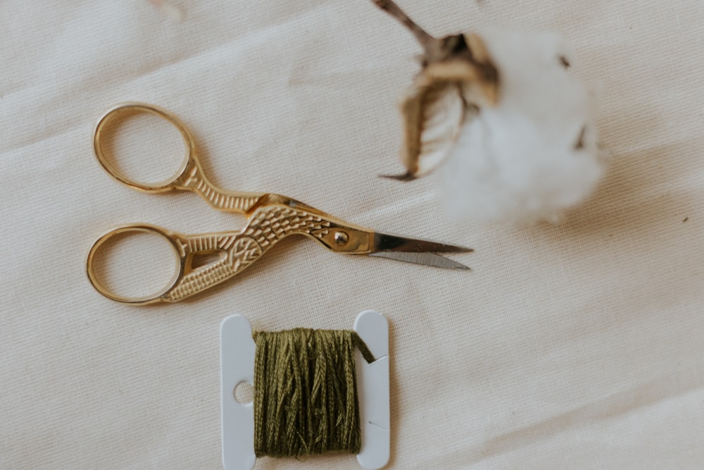 silver scissors beside white and gold scissors