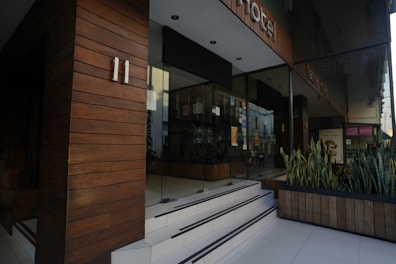 A welcoming office entrance of Rosendale Research with greenery and modern glass doors.