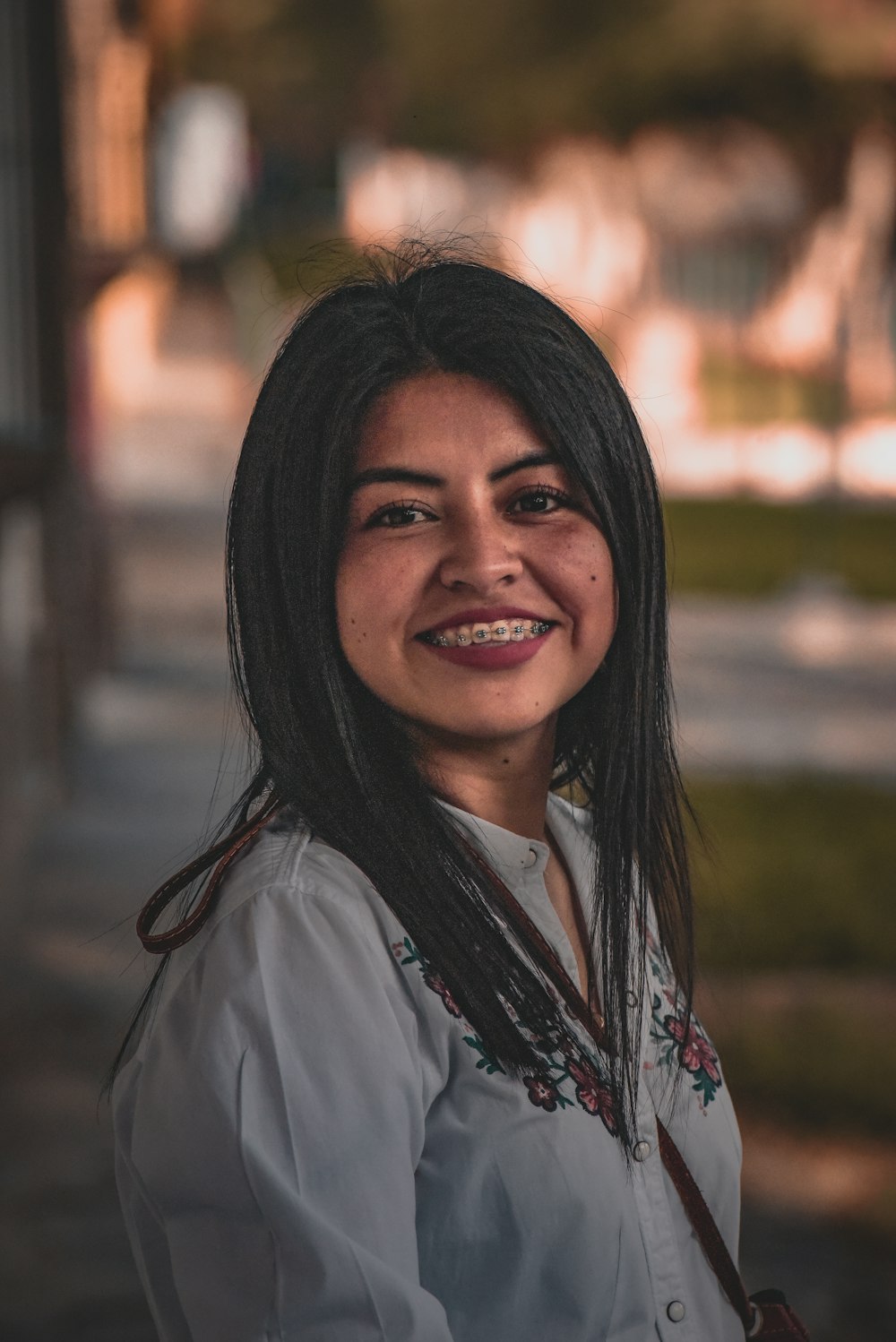 woman in white button up shirt smiling