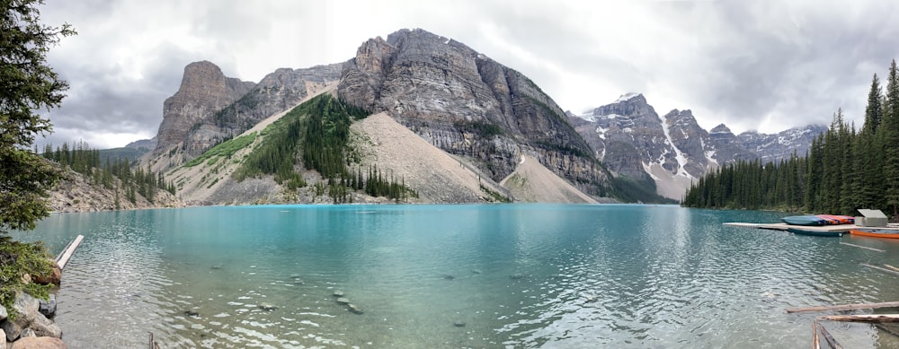 body of water near mountain during daytime