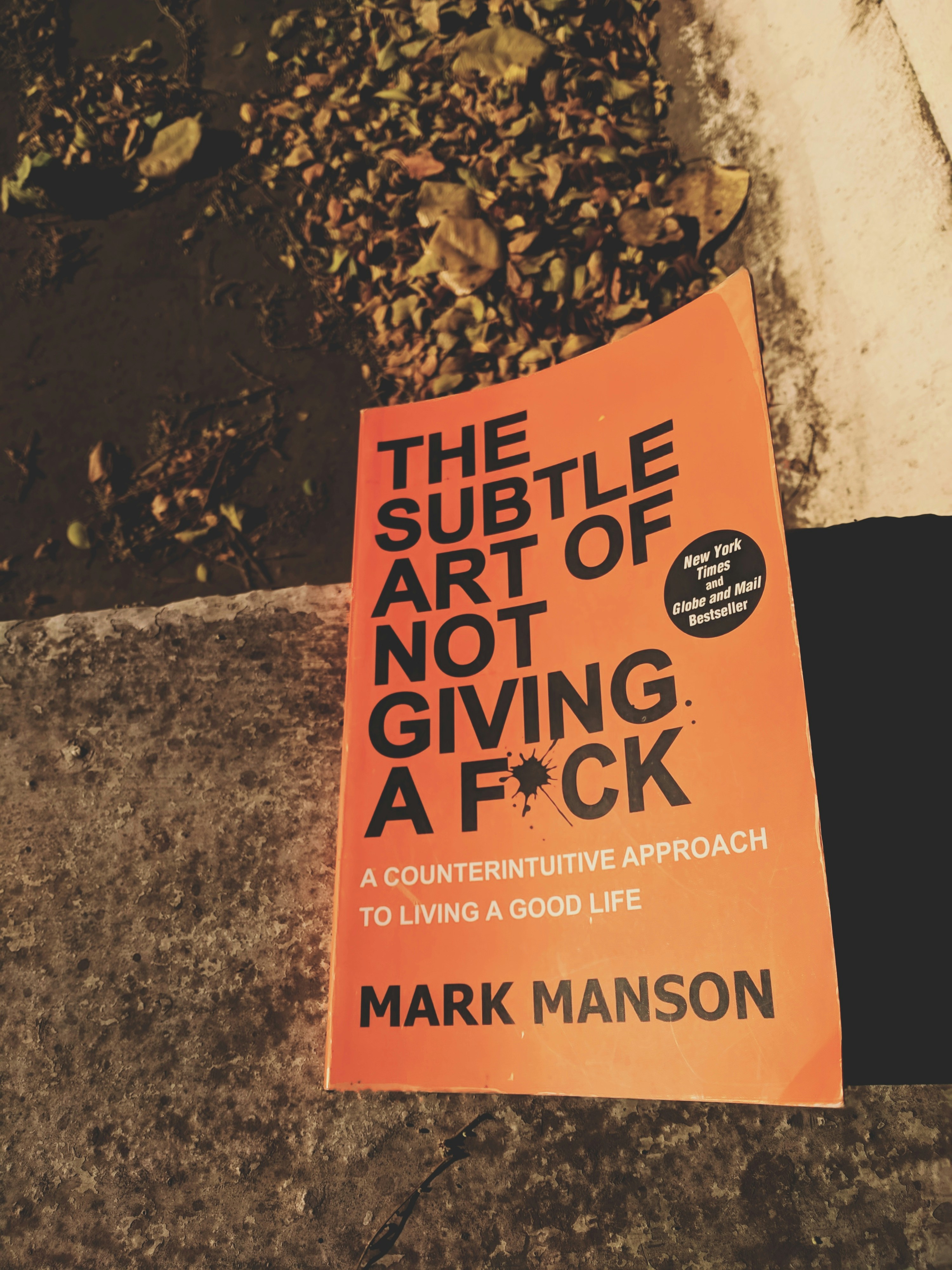 The Subtle Art of Not Giving a F cover with orange and white minimalist design