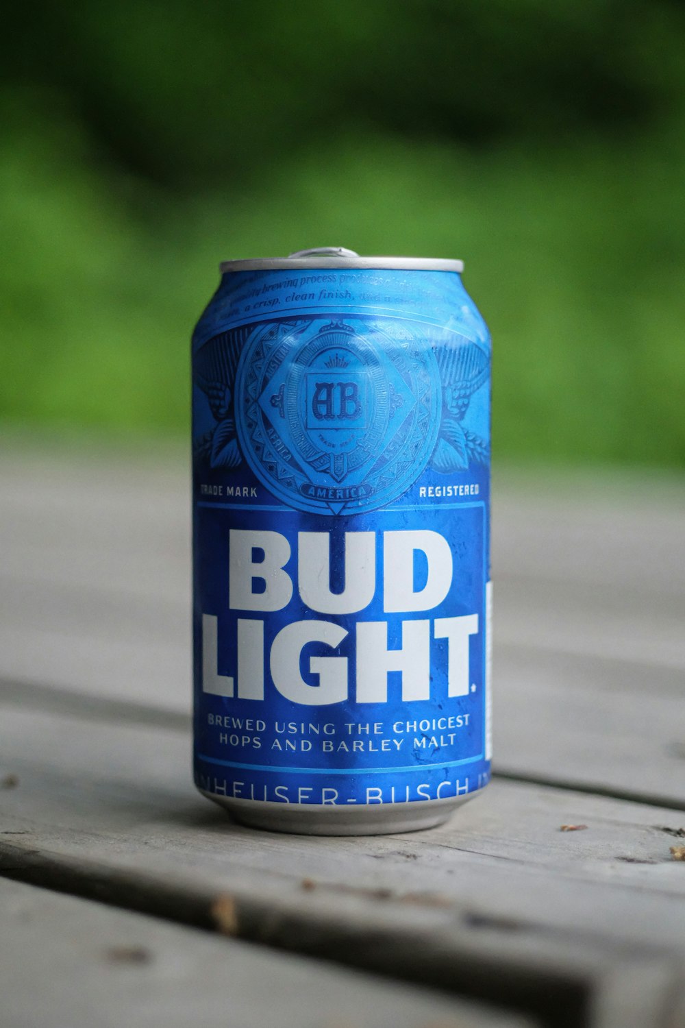 blue bud light can on gray wooden table
