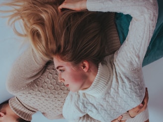 Cozy couple wearing trendy sleepwear, smiling and relaxed at home.
