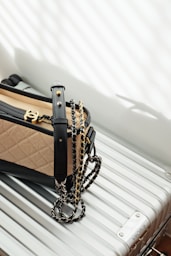 brown and black leather sling bag