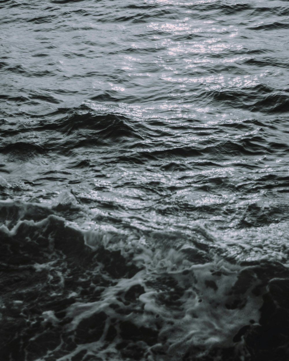 water waves hitting rocks during daytime