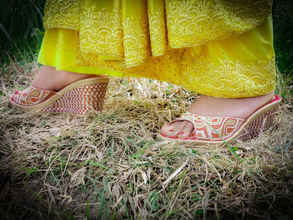 a close up of a person's feet wearing sandals