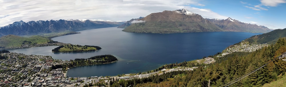 green and brown mountains near body of water during daytime