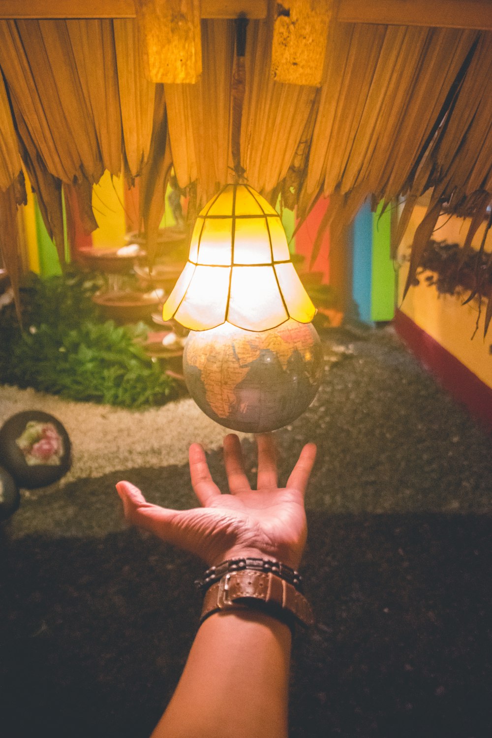 person holding brown and white pendant lamp