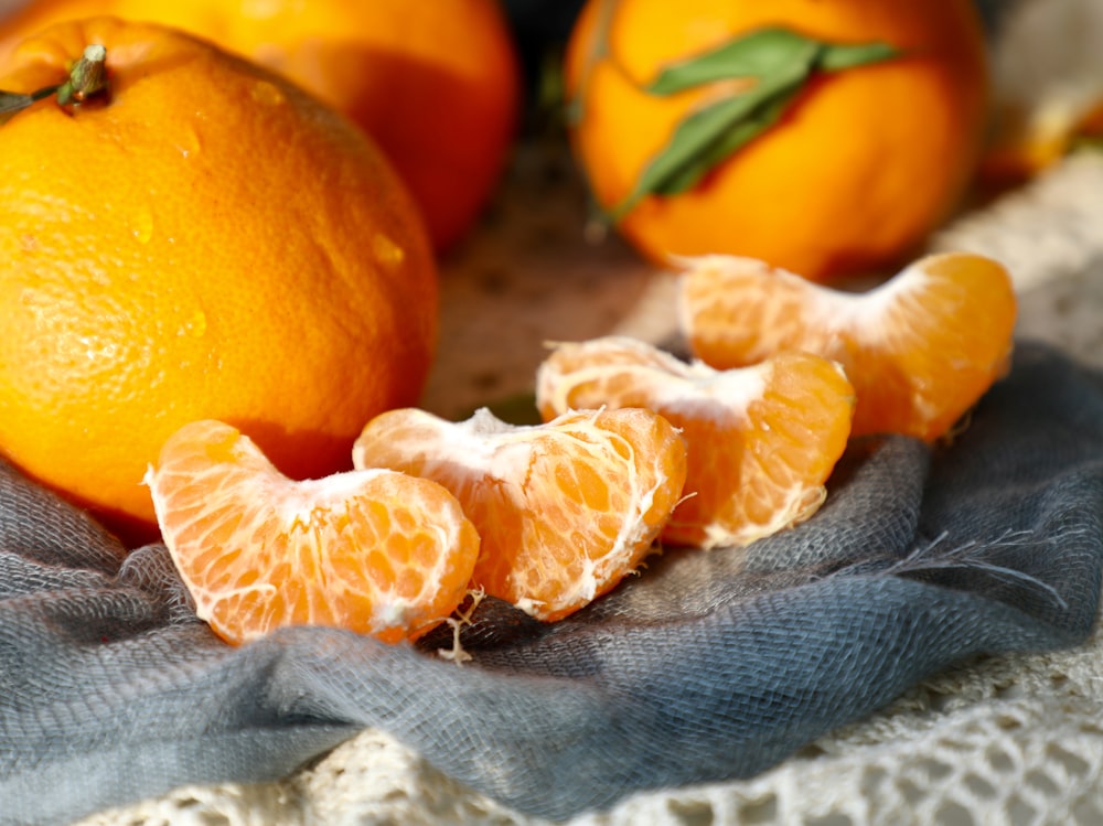 orange fruit on gray textile