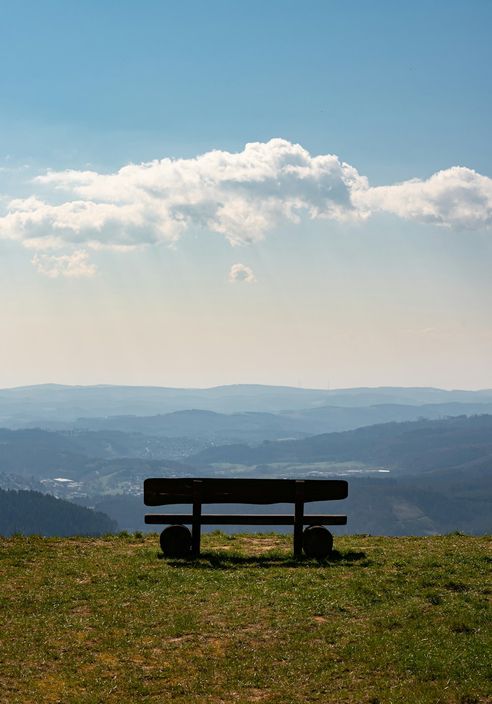 black wooden bench on green grass field during daytime