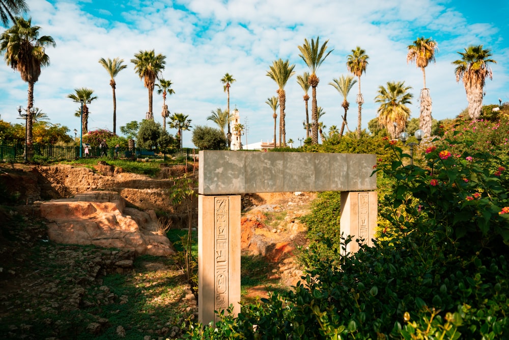 brown concrete cross on brown rock formation under blue sky during daytime