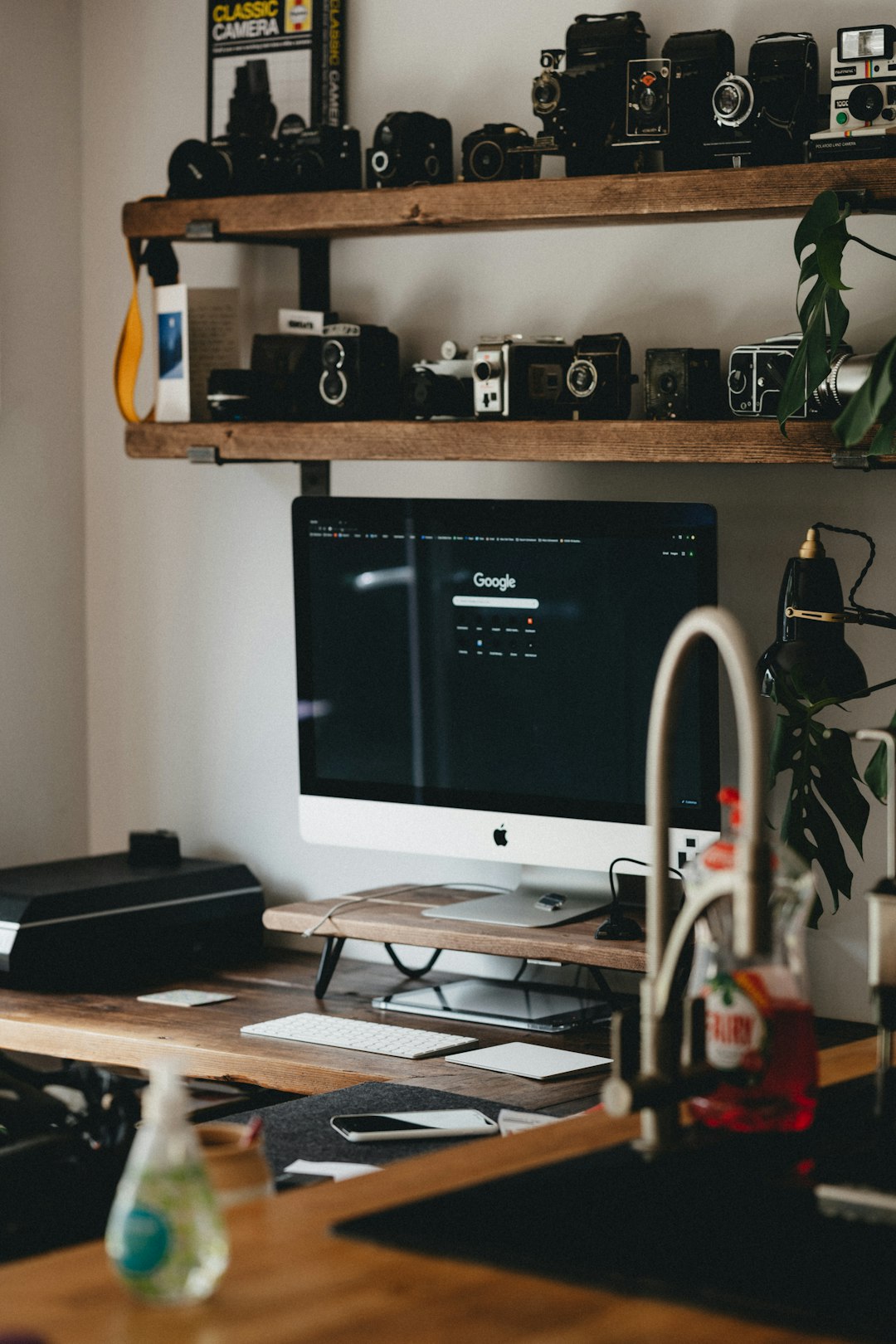 silver imac on brown wooden table