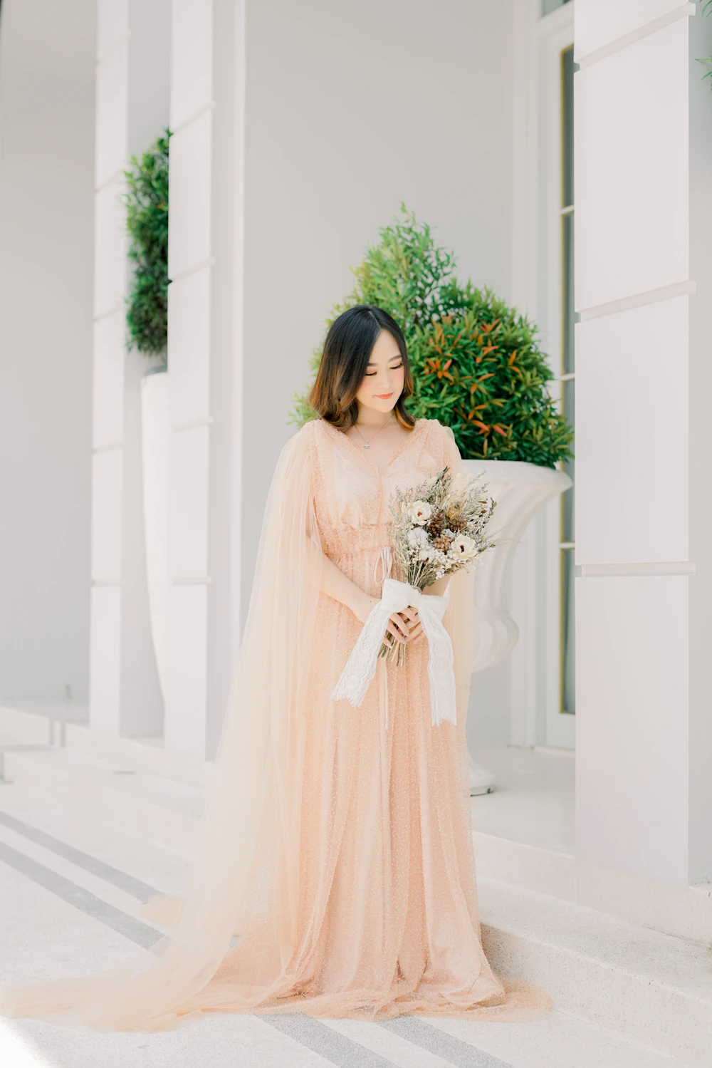 Bride in a wedding dress holding a bouquet of flowers