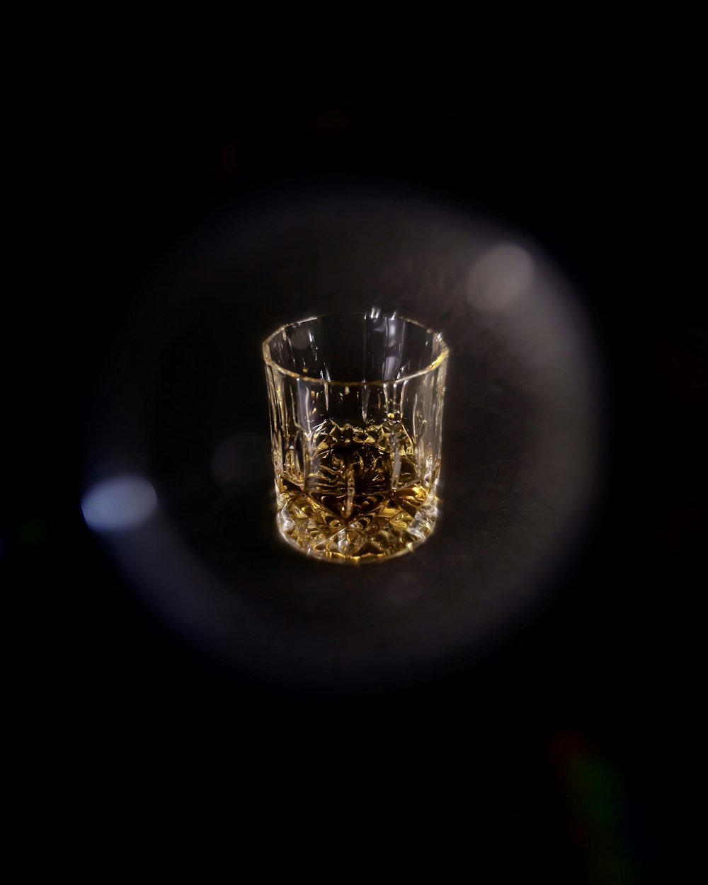 clear shot glass with yellow liquid