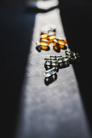 Close-up of sleek black and blue encapsulated supplements with subtle lighting highlighting their texture