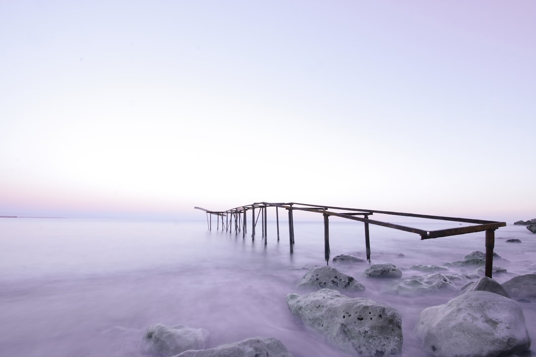 brown wooden dock on white snow covered ground