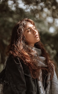 woman in black coat with grey scarf