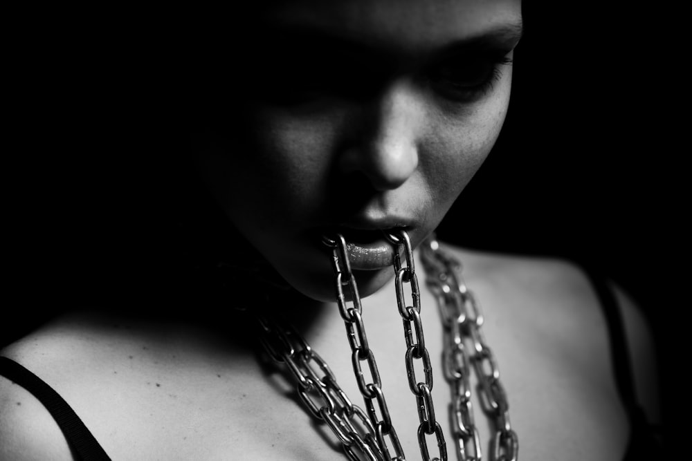 grayscale photo of woman with chain
