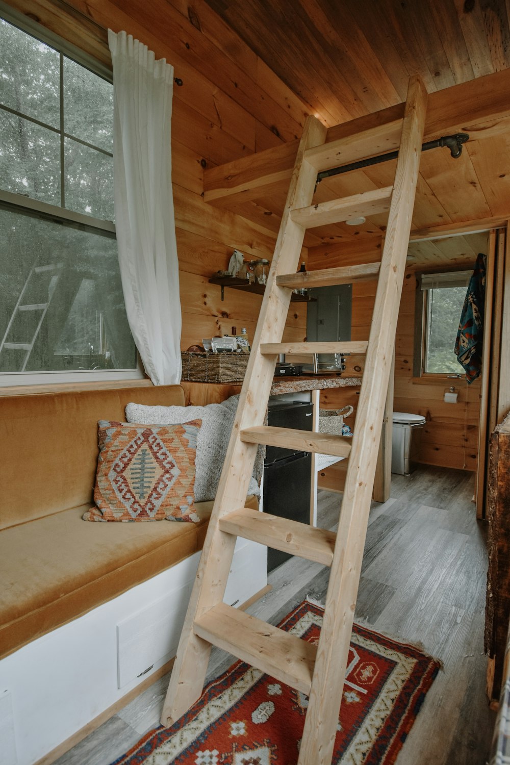 a loft bed with a ladder to the top of it